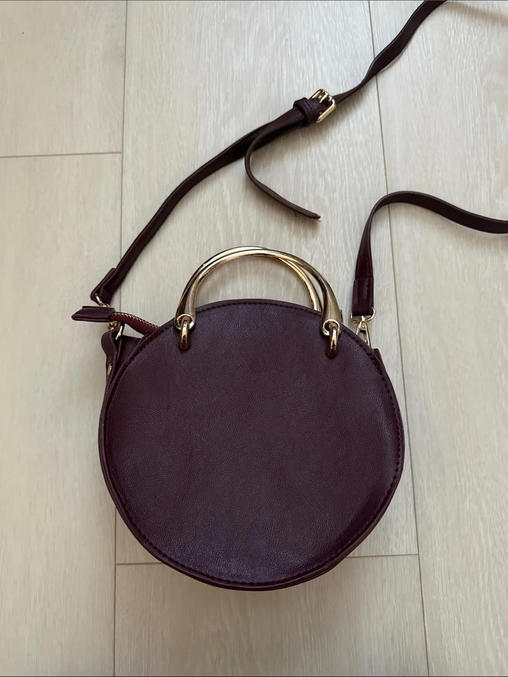Round Crossbody Bag in Plum with Gold Accents